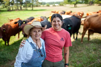 Maria Contreras, left, and her daughter, Lorena Jenkins, stand for a portrait after feeding cattle at their family farm in Blevins, Ark. on Sept. 7, 2023. Photo by Rory Doyle.
